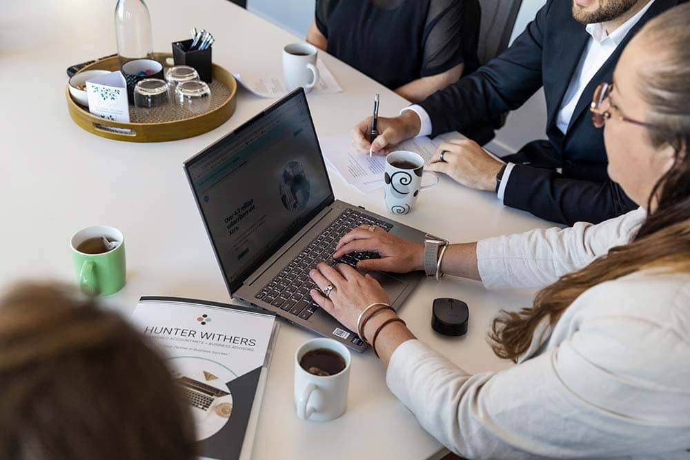 Brigette Fulton, Director at Hunter Withers, demonstrating Xero software to two team members during a staff meeting in Pukekohe.